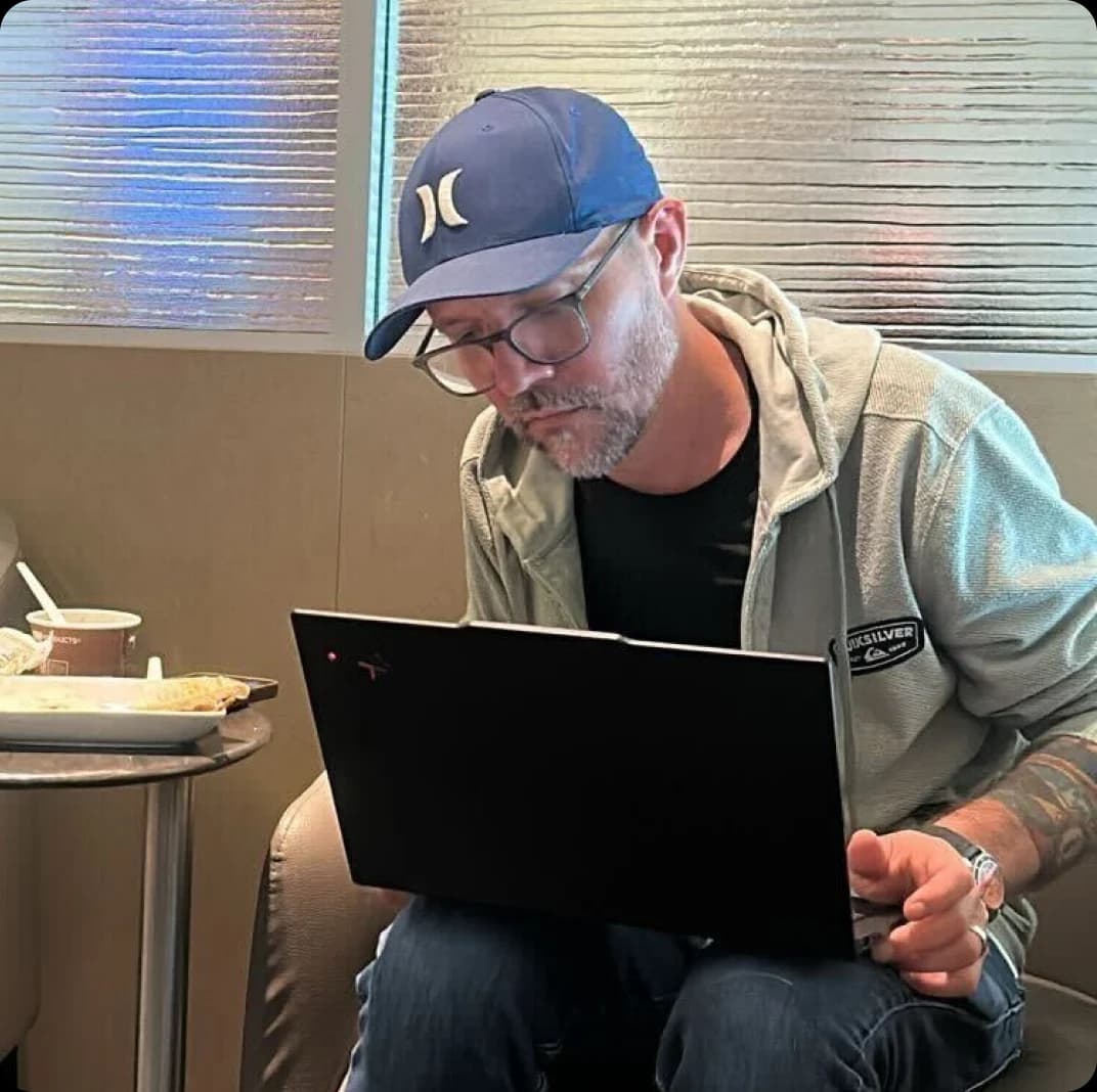 six2eight CEO working on a laptop in the agency office